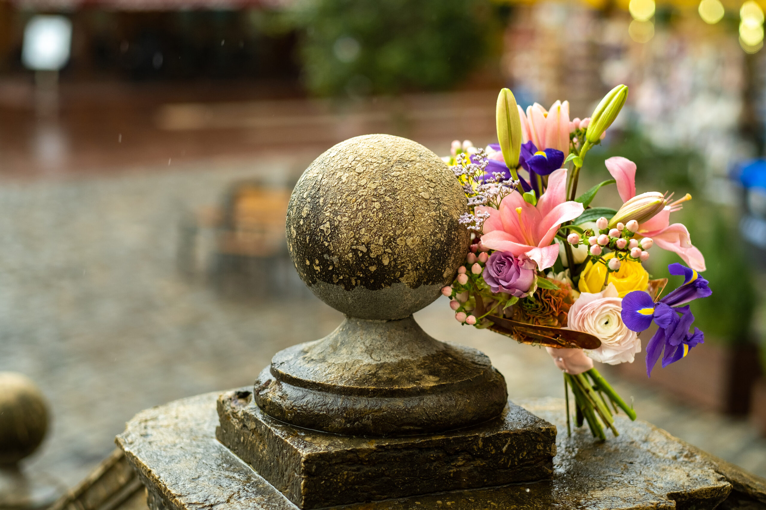 a wedding bouquet with lilies stands on the street in rainy weather.Wedding Decor.