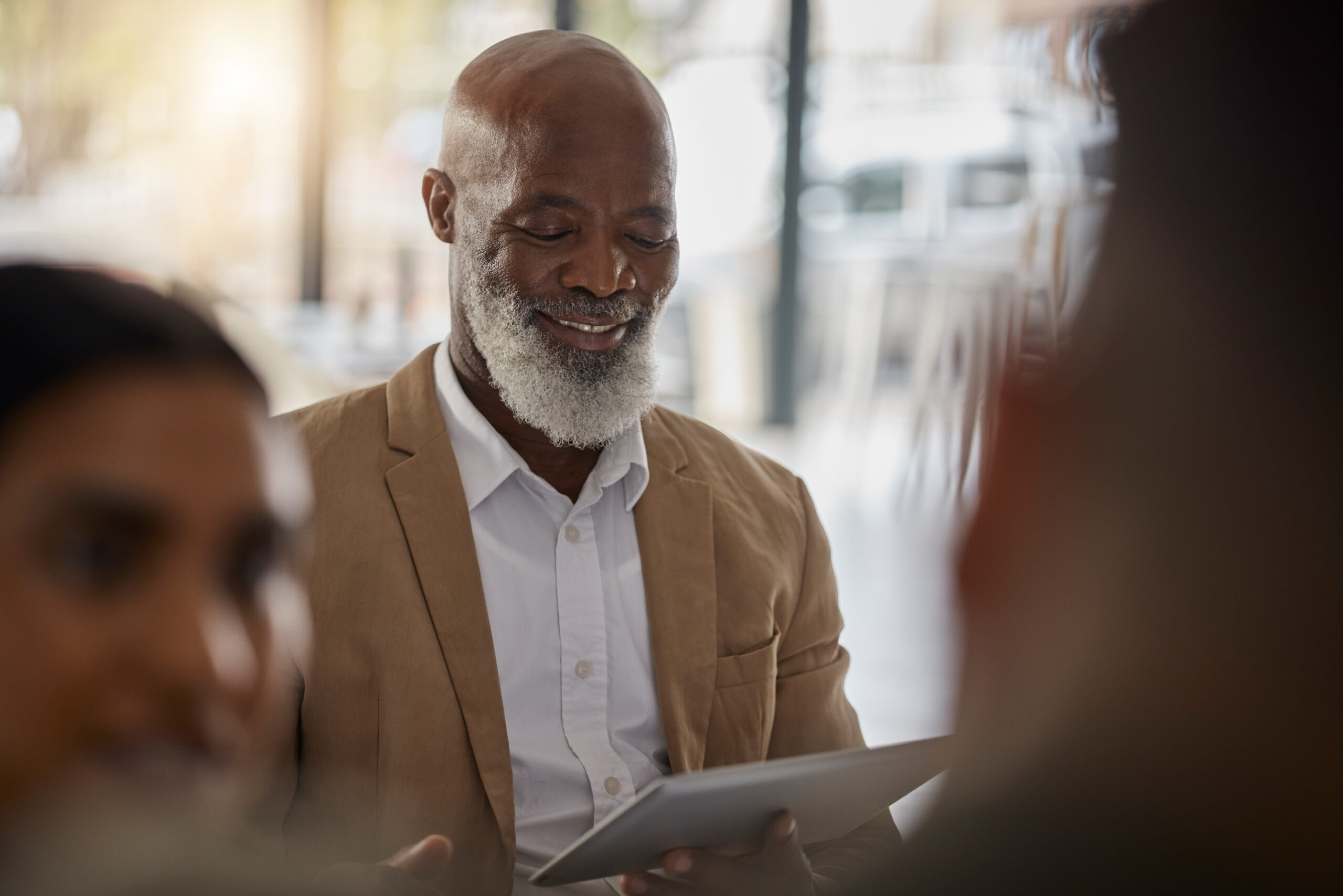 Black man, tablet or boss in meeting for business growth, strategy or collaboration on project in o.